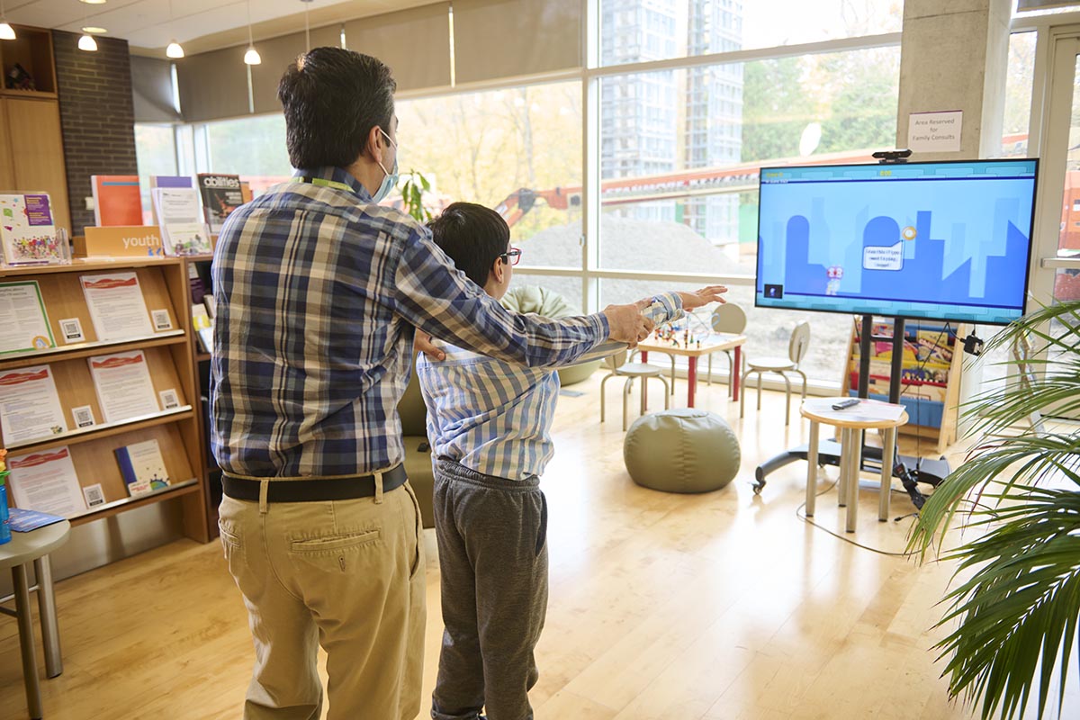 A client plays with Bootle Blast, a movement tracking video game for home-based motor therapy – a Bloorview Research Institute innovation