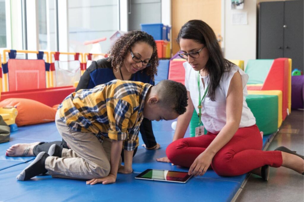 Two people playing with a kid